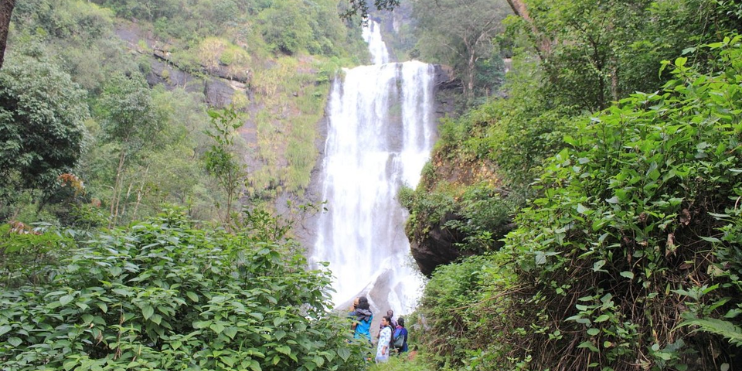 A group of hikers ascending a hillside towards Hebbe Falls.