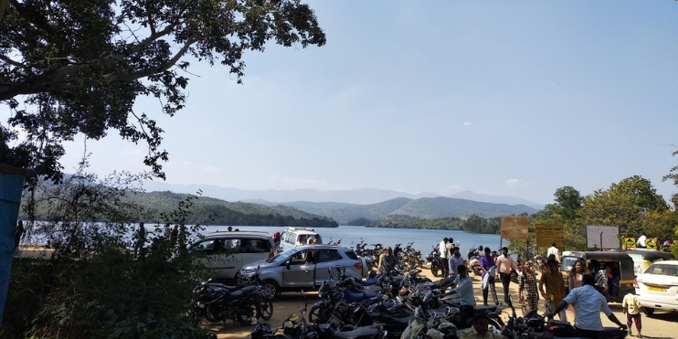 Group of motorcycles by the lake for morning activities at Hirekolale Chikmagalur.