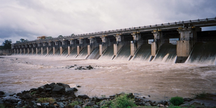 Gajanur Dam prominently displayed, featuring water flowing over its edge, illustrating the blend of natural beauty and human design.