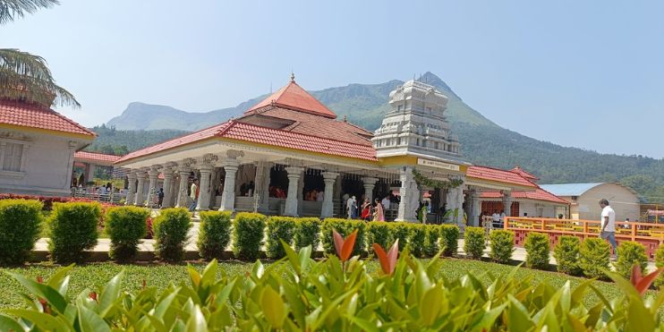 A majestic temple with intricate carvings, set against a mountain backdrop, embodying Hoysala artistry and spiritual tranquility.