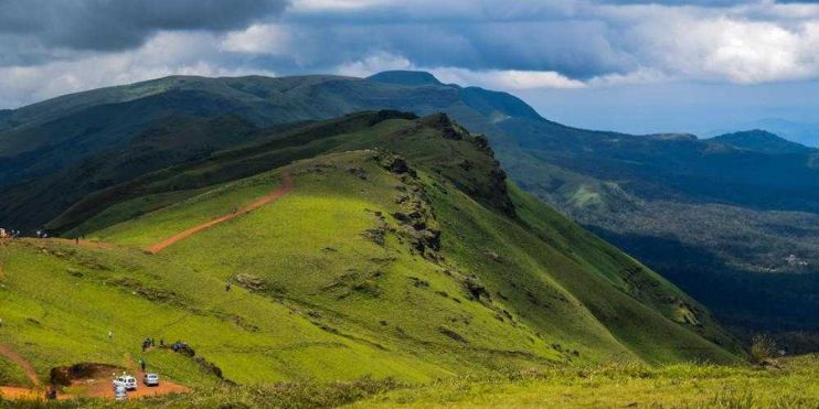 Lush green hills of Kerala, showcasing scenic viewpoints and cascading waterfalls along the trekking trails of Kemmangundi.