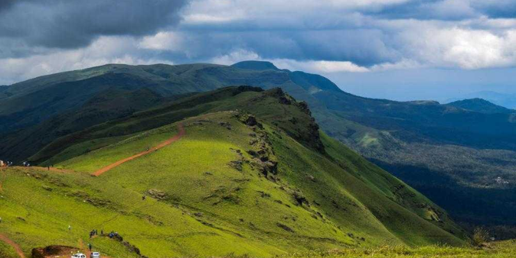 Lush green hills of Kerala, showcasing the serene beauty and tranquility of the Western Ghats, ideal for nature lovers.