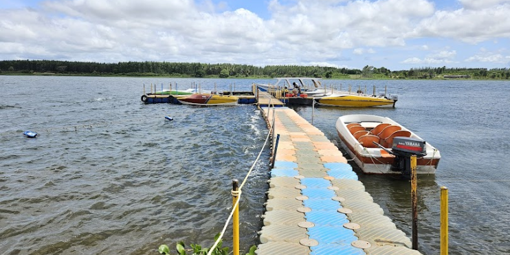 A scenic dock with various boats, highlighting water sports and adventure activities at Yagachi Dam.