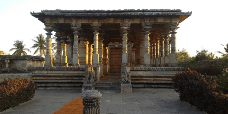 Stone Jain temple with ornate pillars, showcasing exquisite carvings and reflecting the spiritual focus of Jain philosophy.