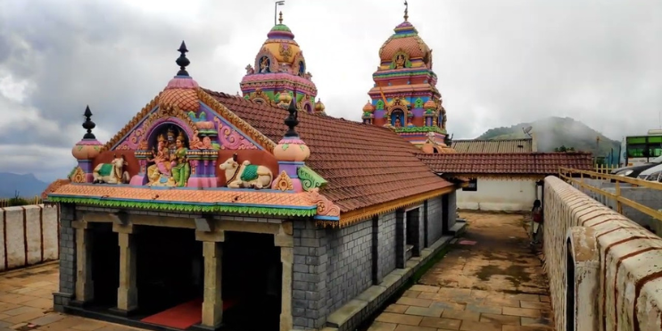 A vibrant temple adorned with colorful roof decorations, symbolizing faith and cultural heritage.