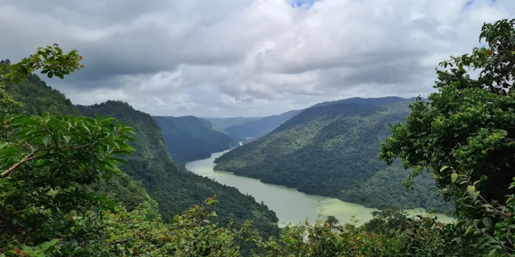 A panoramic view of the river winding through the lush Sharavathi Valley from the mountain summit, showcasing rich biodiversity.